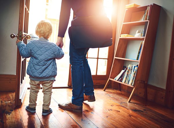Door, leaving or back with parent and child in home together for goodbye or start of morning. Entrance, family or holding hands with person and kid in apartment for travel to school or business