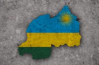 Silhouette of Rwanda in the colours of the Rwandan flag against a concrete backdrop